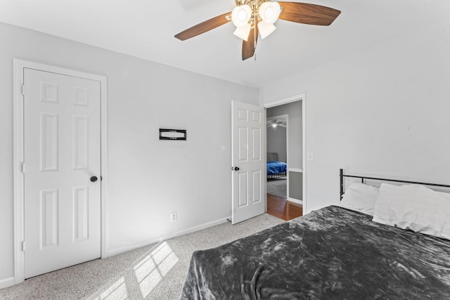 carpeted bedroom featuring a ceiling fan and baseboards