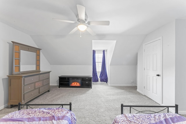 carpeted bedroom featuring lofted ceiling, baseboards, and a ceiling fan