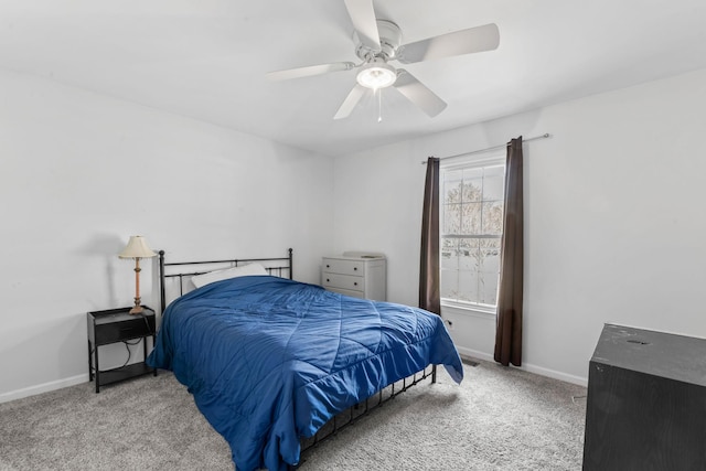 carpeted bedroom featuring a ceiling fan and baseboards