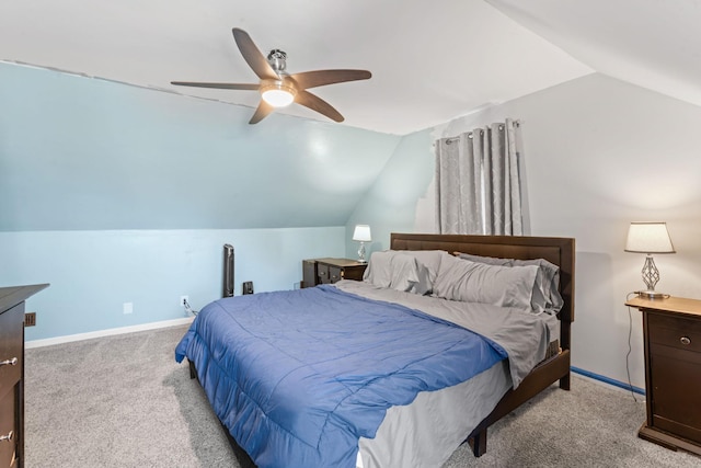 bedroom with light carpet, baseboards, vaulted ceiling, and a ceiling fan