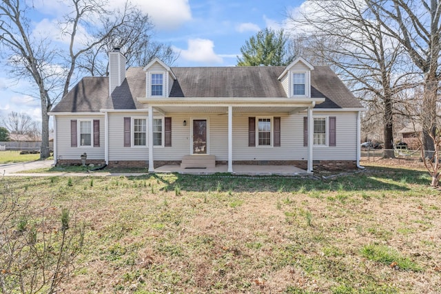 cape cod-style house with a patio, a chimney, crawl space, fence, and a front yard