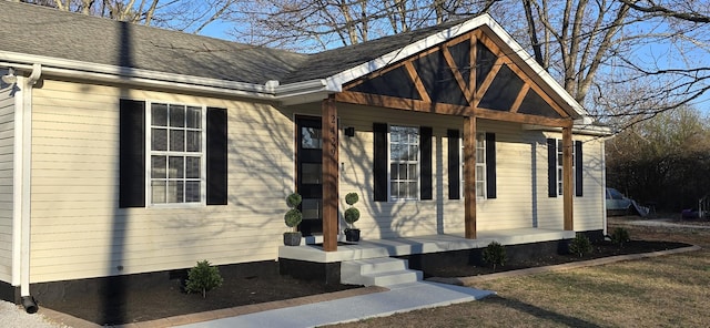 view of front of home featuring a shingled roof and a porch