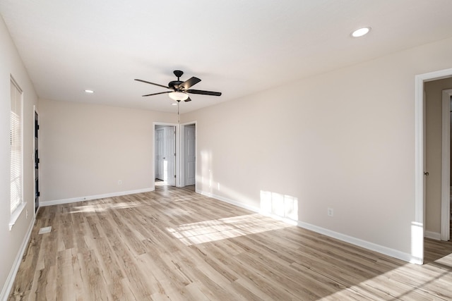 empty room featuring light wood-style floors, baseboards, and recessed lighting