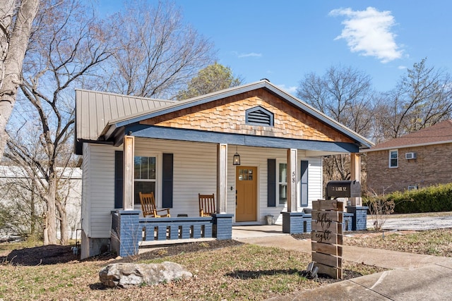 view of front of home featuring covered porch and metal roof