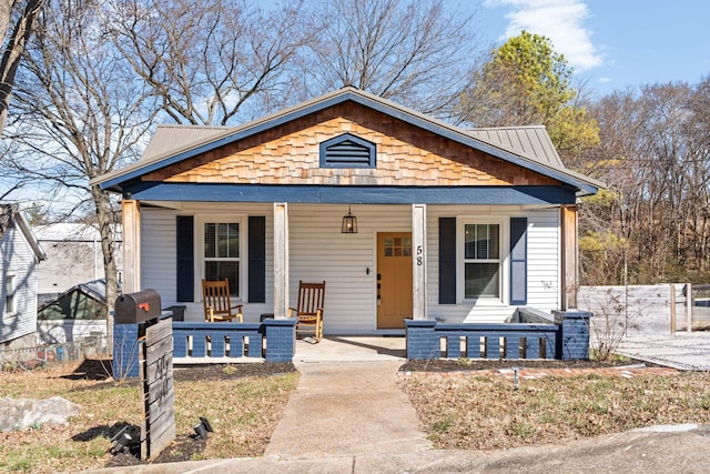 view of front of property with covered porch and metal roof