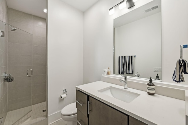 full bath with toilet, a stall shower, visible vents, and vanity