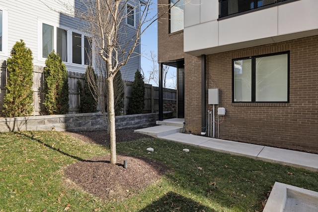 exterior space with a yard and brick siding