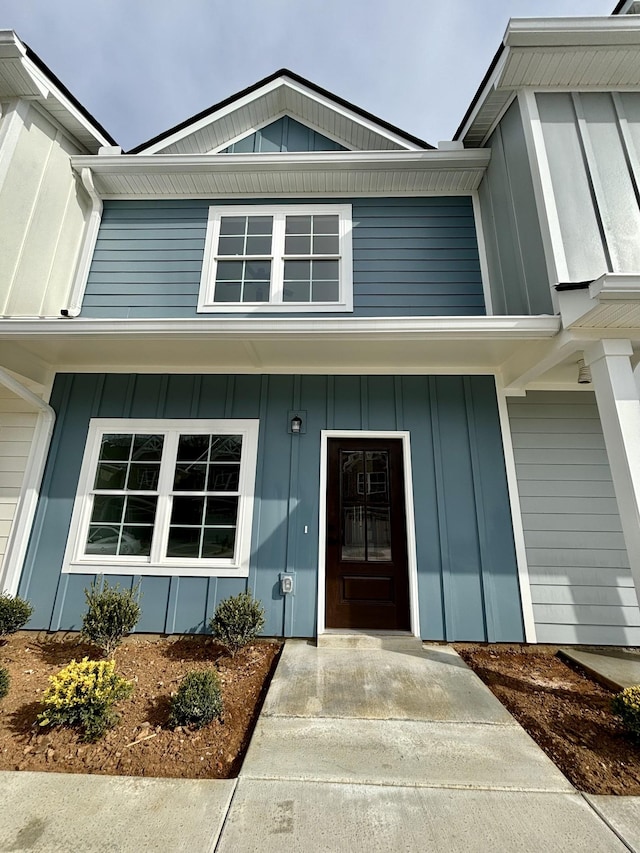 entrance to property with a porch and board and batten siding