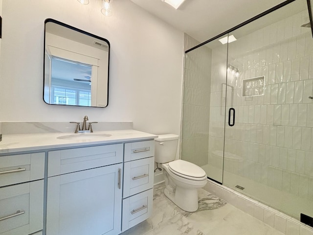 bathroom featuring marble finish floor, a stall shower, vanity, and toilet