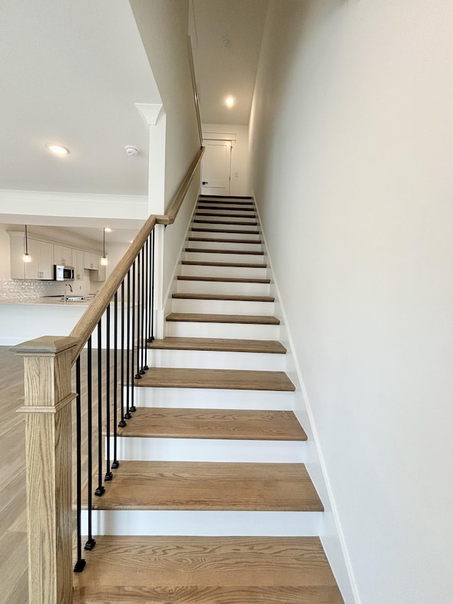 stairway with recessed lighting and baseboards