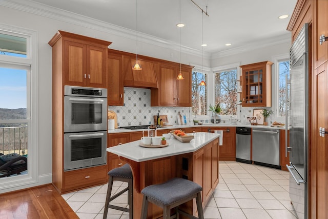 kitchen with brown cabinets, stainless steel appliances, and light countertops