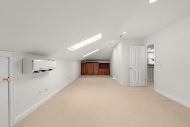 bonus room featuring recessed lighting, light colored carpet, lofted ceiling with skylight, a wall mounted air conditioner, and baseboards