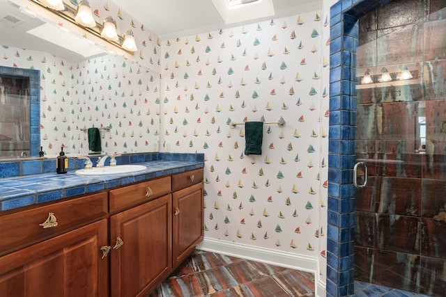 full bathroom featuring visible vents, a stall shower, vanity, baseboards, and wallpapered walls