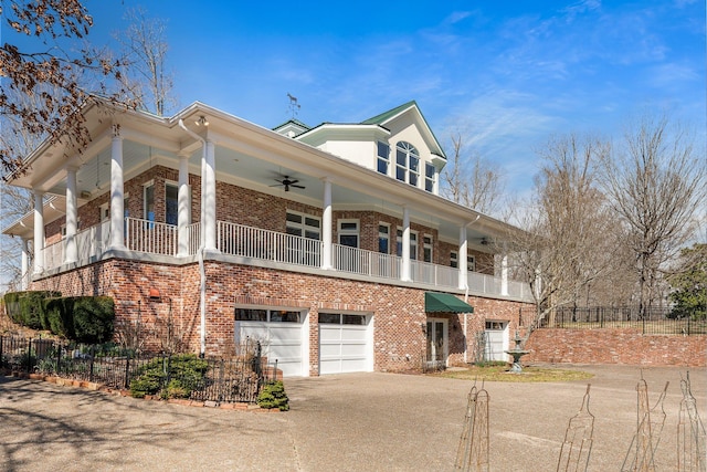 view of front of property featuring a garage, brick siding, fence, and driveway