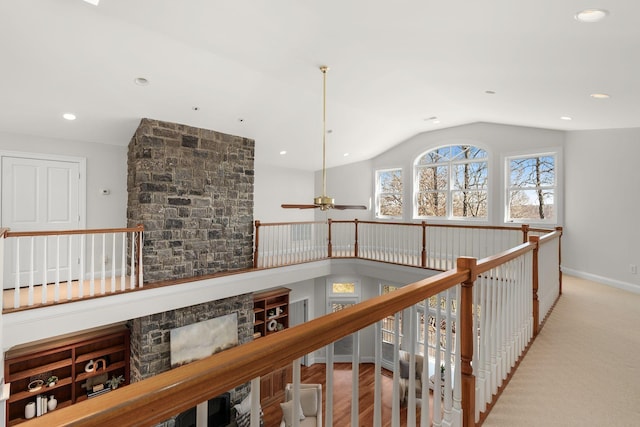 hall with an upstairs landing, lofted ceiling, baseboards, and recessed lighting