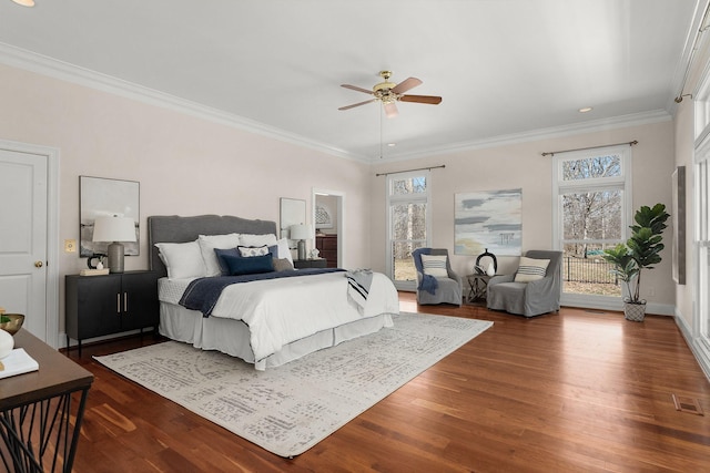 bedroom featuring dark wood-style flooring, multiple windows, visible vents, and crown molding