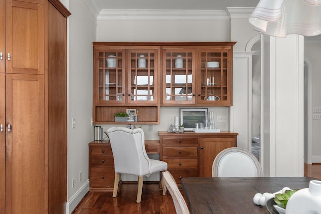 interior space with dark wood-type flooring, ornamental molding, and baseboards