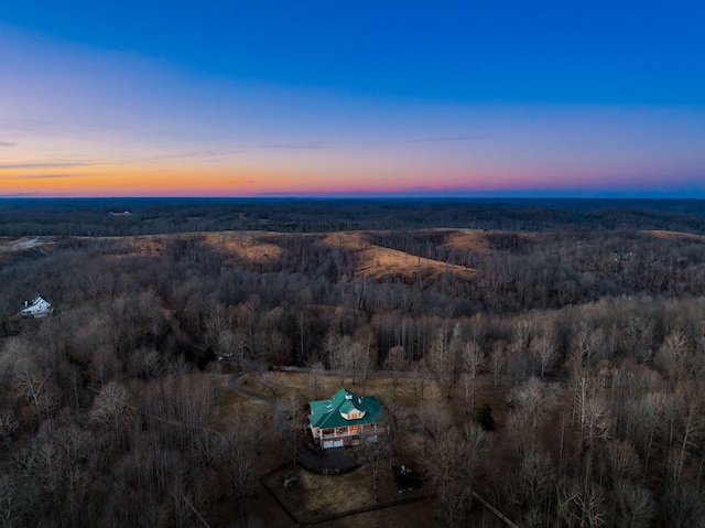 birds eye view of property featuring a view of trees