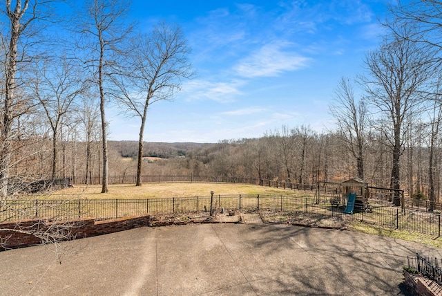 view of yard featuring fence and a view of trees