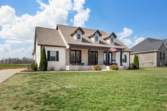 view of front of home with a front lawn, roof with shingles, and brick siding