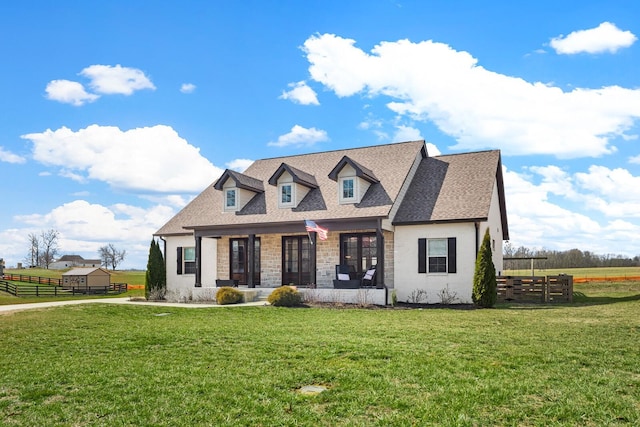 view of front of property with roof with shingles, fence, and a front lawn