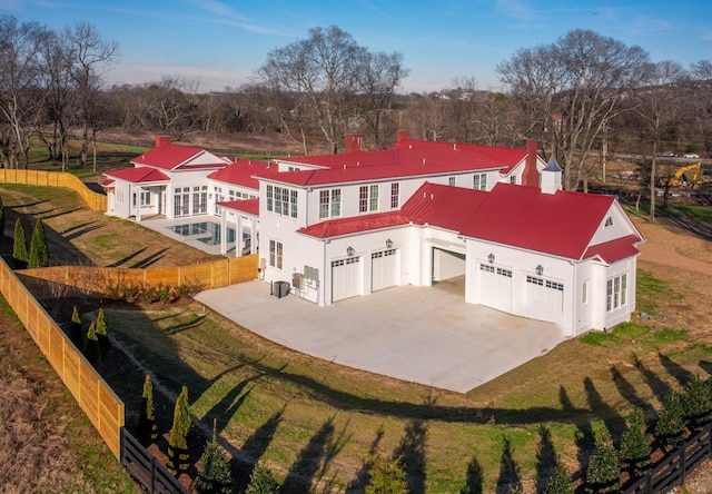 exterior space with driveway, a garage, fence, and stucco siding