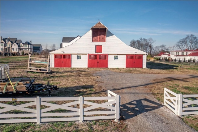 view of barn with fence and central AC