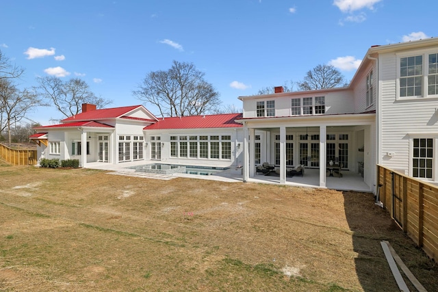 rear view of house with a patio area, fence, french doors, and a chimney