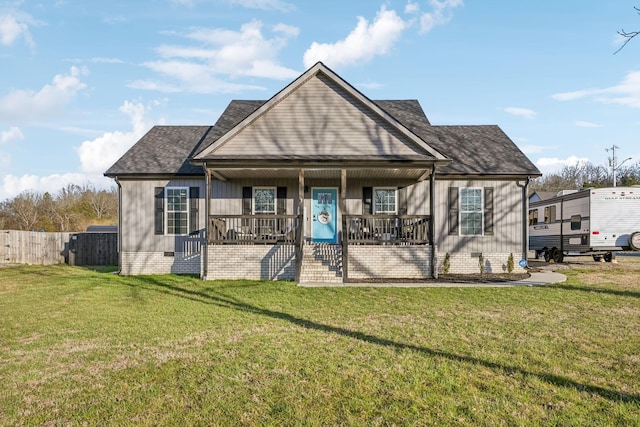 view of front of property with roof with shingles, a porch, crawl space, fence, and a front lawn