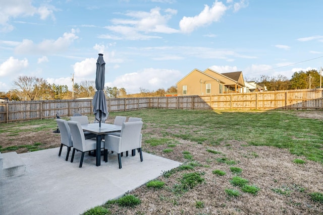 view of yard with a patio, outdoor dining area, and a fenced backyard