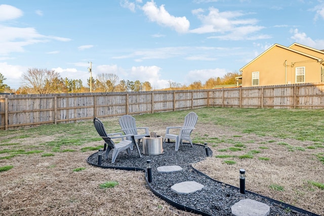 view of yard featuring an outdoor fire pit and a fenced backyard