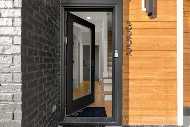 entrance to property featuring brick siding