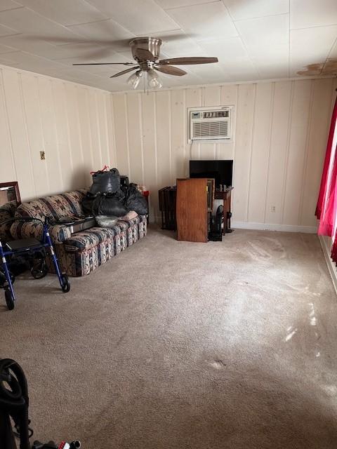 bedroom featuring carpet, ceiling fan, and an AC wall unit