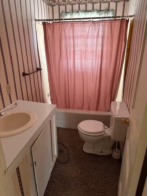 bathroom with toilet, shower / bathtub combination with curtain, and vanity