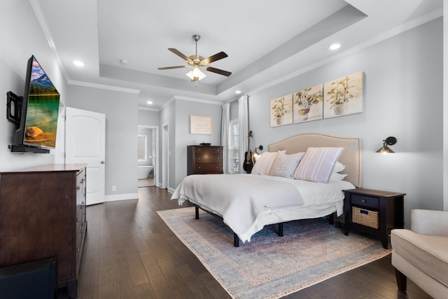 bedroom with crown molding, dark wood-style flooring, a raised ceiling, and baseboards