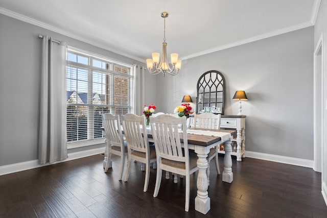 dining room featuring a notable chandelier, ornamental molding, wood finished floors, and baseboards