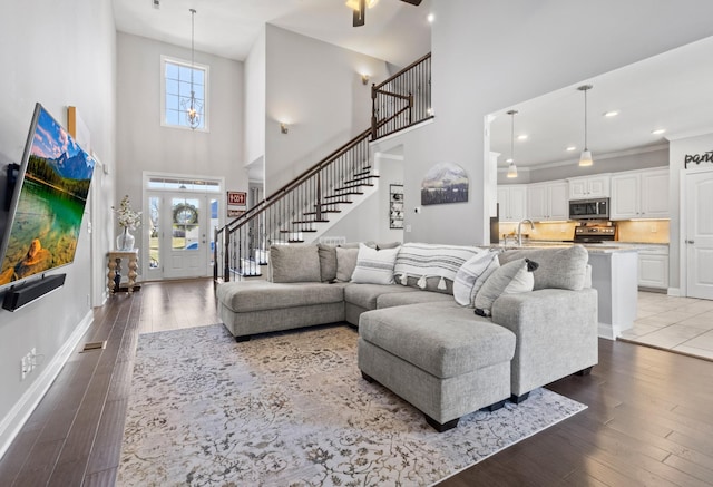 living area with stairs, baseboards, dark wood-style flooring, and recessed lighting