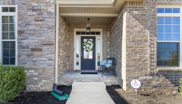 doorway to property with brick siding