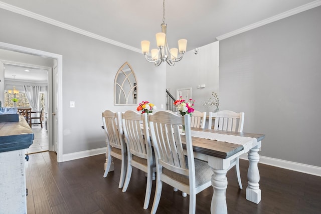 dining area featuring ornamental molding, wood finished floors, baseboards, and an inviting chandelier