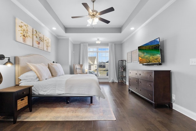 bedroom with baseboards, a tray ceiling, dark wood-style flooring, and ornamental molding