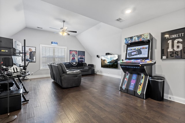 living area featuring lofted ceiling, baseboards, visible vents, and wood finished floors