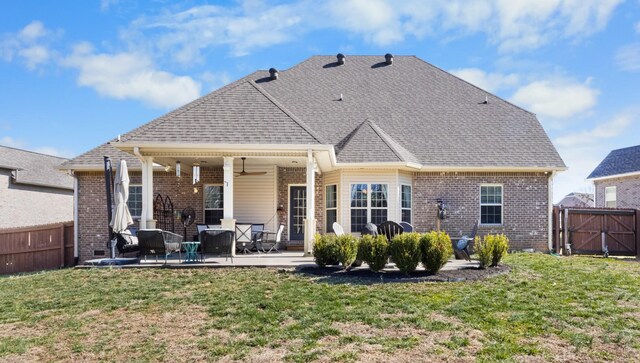 back of property featuring a patio area, fence, a ceiling fan, and a yard