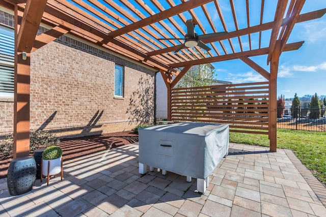 view of patio with a ceiling fan, fence, and a pergola