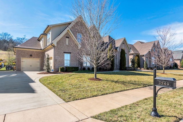 view of front of property with a garage, a front lawn, concrete driveway, and brick siding