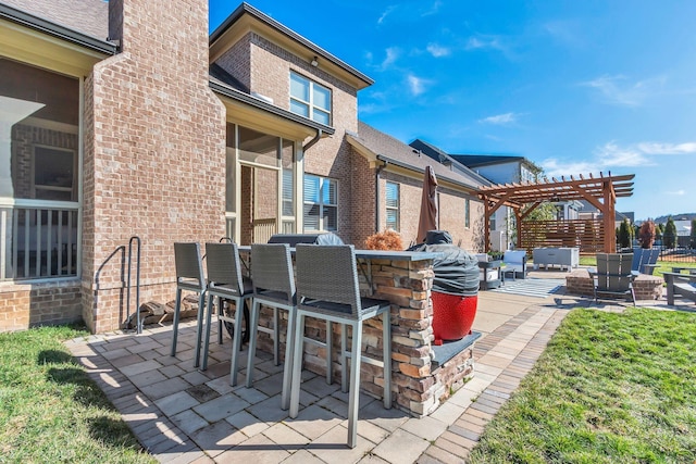 view of patio / terrace with outdoor dry bar and a pergola