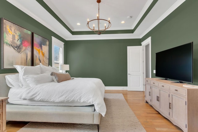 bedroom with a chandelier, light wood-style flooring, recessed lighting, a raised ceiling, and crown molding