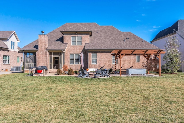 back of property with roof with shingles, brick siding, a lawn, a patio area, and a pergola