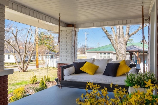 view of patio / terrace with fence, an outdoor living space, and a gazebo