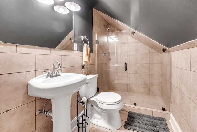 full bath with toilet, a shower stall, tile walls, and tile patterned floors