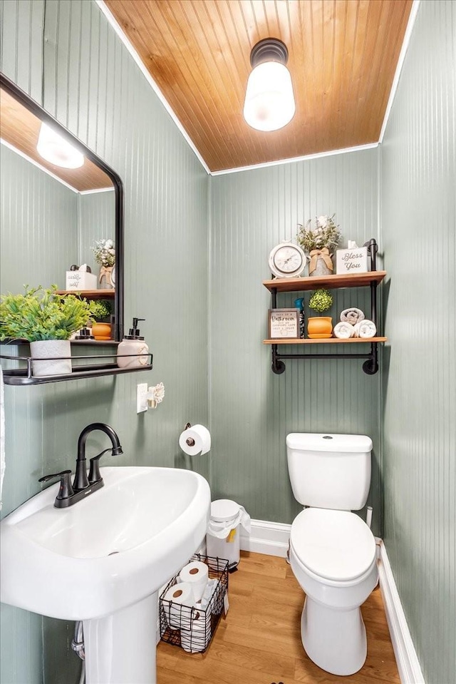 bathroom with toilet, wooden ceiling, a sink, and wood finished floors